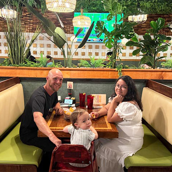 Family with their baby enjoying a meal in the redesigned dining room